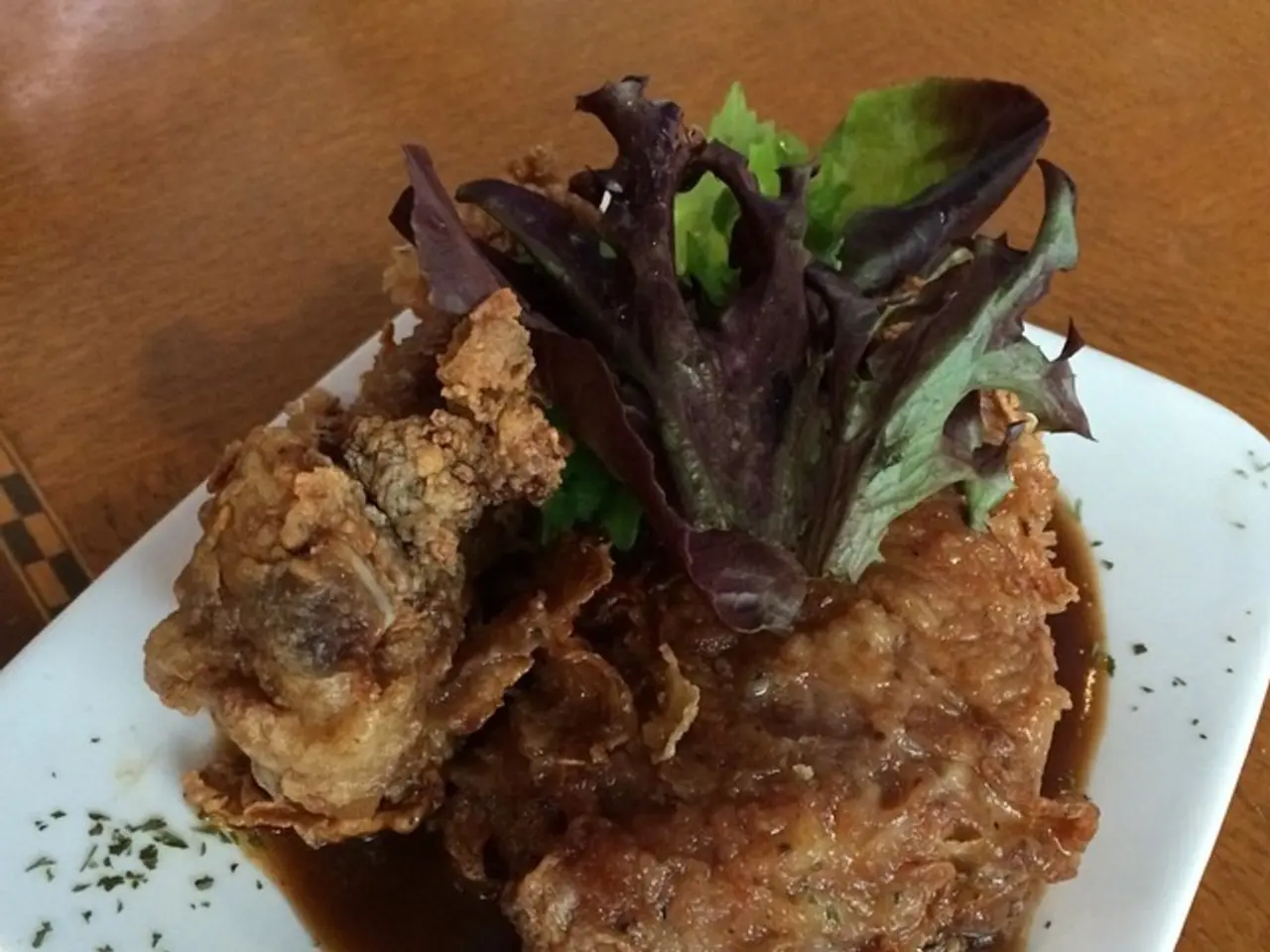 In this image there is a plate on the table. In the plate there is some dish on which there are...