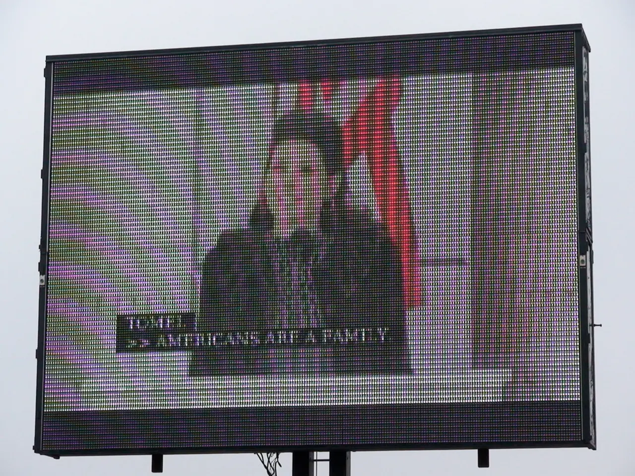 This picture shows a screen and we see a woman speaking at a podium with the help of a microphone.