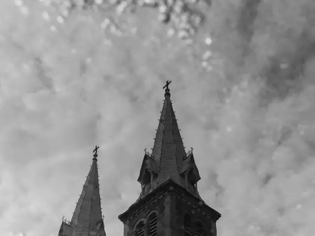 In this picture there is a building. At the top there are clouds. In the foreground it looks fog on...
