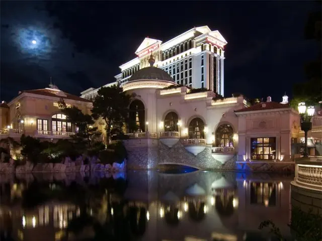 This picture shows buildings and we see water and trees and we see pole lights and we see moon in...