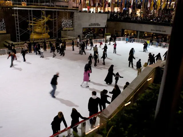 In this image there are so many people doing snow skating on the snow, which is in the middle of...