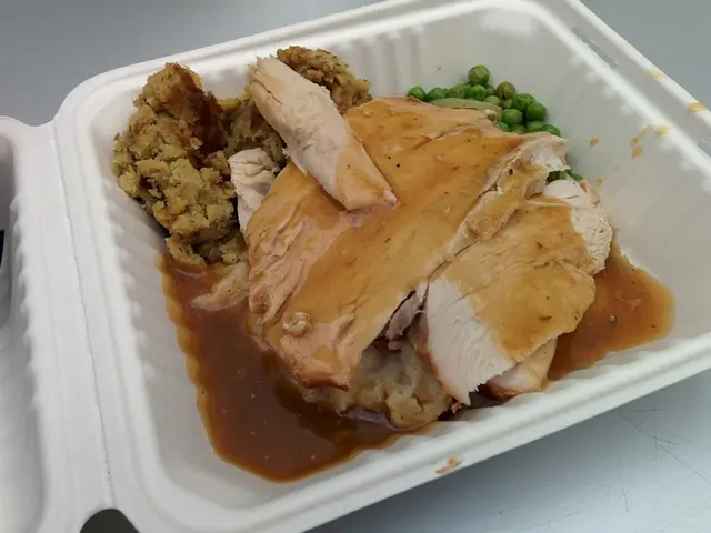 In this picture there is a box in the center of the image, which contains food items.