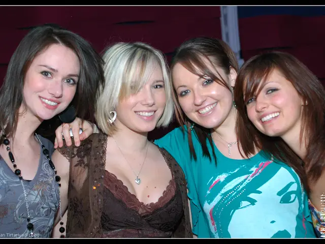 In this image I can see four women standing and wearing different color dress. Back I can see...